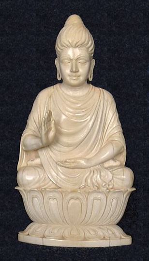 Unusual rendering of Ghanadaran style Shakyamuni Buddha exquisitely carved in ivory seated in 'Gesture of Fearlessness' or 'blessing'  or abhaya mudra from early 20th century - (7 in. tall)