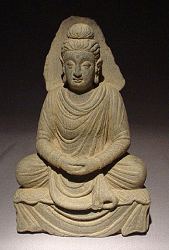 See a full page on this extraordinary Gray Ghandaran Schist seated Buddha (9in tall) - ca. 300 AD